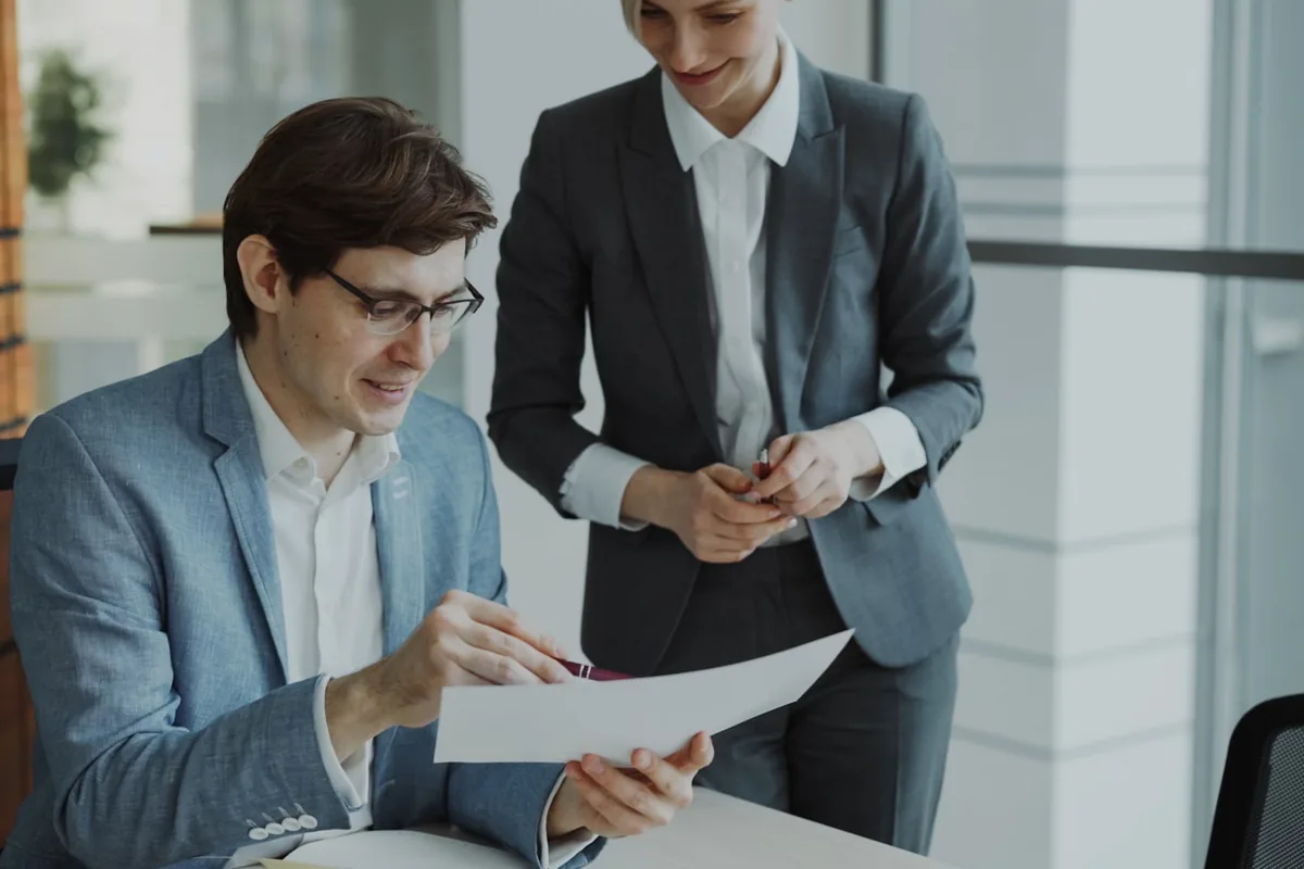 A bankruptcy attorney reviewing financial documents with a client.