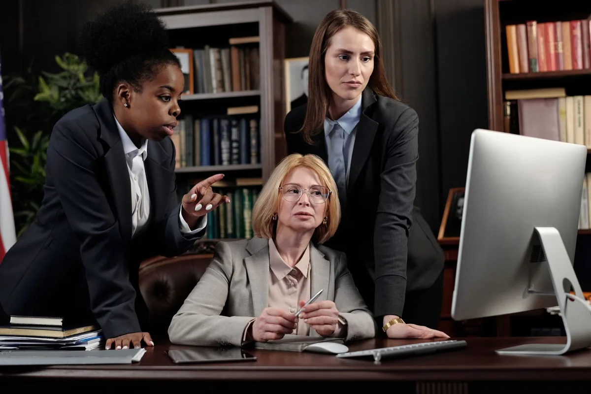 A Rule Seven team reviewing local search rankings for a law firm on a shared screen.