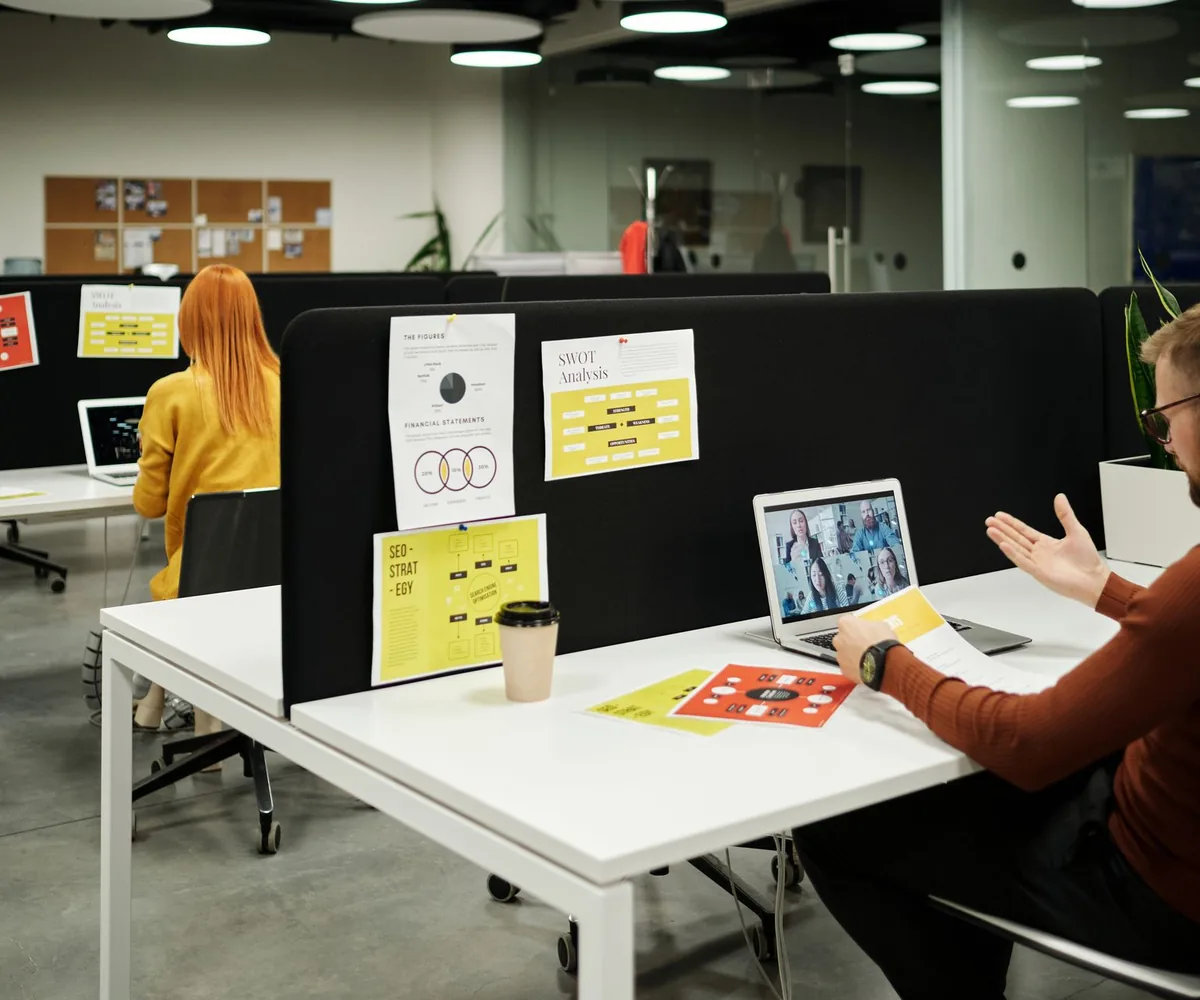 A marketing team reviewing law-firm website designs on screen.