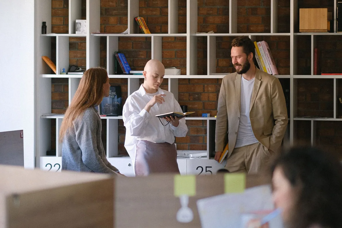 The Rule Seven marketing team reviewing a client's campaign strategy together in their office.